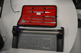 *Set of Stainless Steel Implements Including Scissor, Tweezers, and a Paper Trimmer