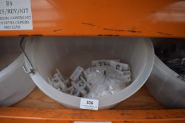 *Feed Bucket Containing White Plastic Door Retainers