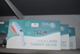 Three Osalis Cold Laser Therapy Devices