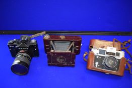 Three Vintage Camera Including Zenit 12XP, Pedfed 4, and a Kodak No.02 Hawkette