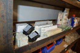 Contents of Shelf to Include Assorted Power Supplies, Switches, Smoke Detector Testers, etc.