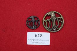 Two Third Reich period eagle badges with swastika motifs, circular in form with stylised eagle and