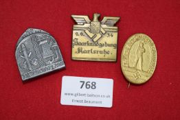 Three German Day Badges, including: silvered badge Gautag Essen 1935 with sword, hammer and