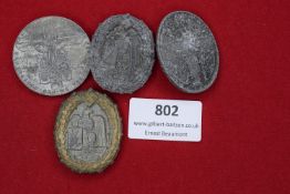 Mixed lot including four German commemorative badges, all showing varying degrees of corrosion and