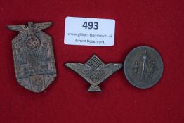 Three German tinnies: a shield-shaped bronze example for the NS Beamten Treffen, Gau Westfalen-