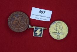 Three badges: a circular brown pressed fibre badge for Gautag Osthannover der NSDAP 1937, showing