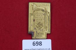 A gilt rectangular badge marked “Sonnenwende Zeitenwende” (Solstice – Turning Point), with lion