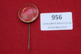 German Charity Stickpin – A circular red enamel stickpin with gilt lettering reading 