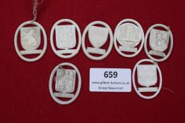Seven WHW plastic city crest badges in white, including Luxemburg, St. Wipert, Brünn, Memel, Linz,