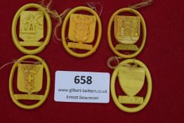 Five WHW plastic city crest badges in yellow, including Katowitz, Eupen, Linz, Danzig, and Brünn.