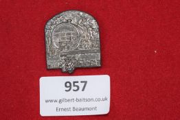 A silvered pressed-tin event badge depicting a large wine barrel with the legend “Bad Dürkheim”,