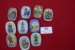 A collection of ten textile souvenir badges mounted on metal frames with pin fittings, each