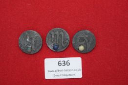 A group of three circular German badges, each displaying a different zodiac sign (Pisces, Scorpio,