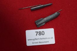 Two miniature stick pins in the form of ordnance: one artillery shell and one mortar round, both