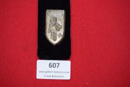 A rare Danzig political badge, shield-shaped bronze example with raised city arms and swastika,