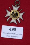 A German War Veterans’ Honour Cross, with crossed swords, silvered with gilt and enamelled central