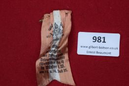 German Fabric Day Badge, orange and white striped silk ribbon, printed with event details dated 13–