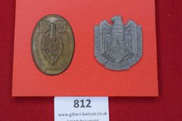 Two German badges, including a bronze oval Kriegsopfertag 1933 badge with sword, swastika and