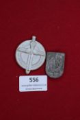 Two German SA tinnies, one large round badge with sword and eagle motif dated 1939, the other
