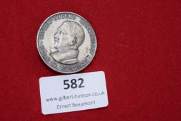 A Hitler Youth commemorative badge, circular in form, depicting a profile bust of Adolf Hitler, with