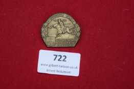 A bronze badge depicting a mounted lancer with city arms below, inscribed “Endlich Frei” and “