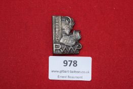 German Badge, featuring a bull’s head with shield and stylised lettering, struck in metal with pin-