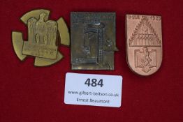 Three tinnies: a gilt cross-shaped badge for the 5th Kreistag der NSDAP, Oker 1937 with eagle and