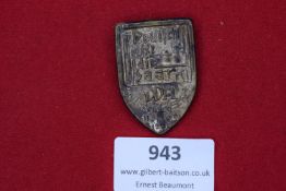 A pressed metal tinnie for the Deutsche Arbeitsfront (DAF) event of 1933. The shield form carries