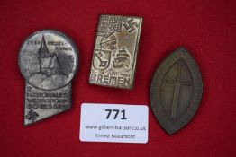 Three German event badges, comprising Oberursel-Tannus Wehrsport shooting badge, 1934 Bremen