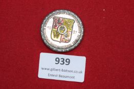 A circular tin badge with coloured enamelled crest, inscribed 12. Deutsches Sängerbundesfest,