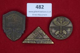 Three badges: a shield-shaped tinnie for the Kriegsopfer Grenzland Kundgebung, Passau 1933; a