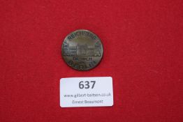 A circular bronze-finish badge depicting the Reichstag building, inscribed “Reichstag Besuch in