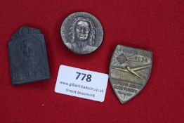 Three German badges: one blackened tin Karl I commemorative plaque dated 1917, one circular portrait