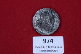 Large round commemorative badge featuring soldier’s helmet, grape cluster, and symbols of