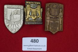 Three tinnies: a silvered shield-shaped badge for the Fest der Deutschen Schule, Uelzen 1933; a gilt