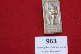 A rectangular pressed tin participant’s badge for the Deutsche Turnerschaft (German Gymnastics