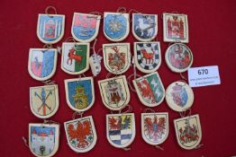A collection of approx. twenty WHW wooden shield-form badges, each decorated with a heraldic