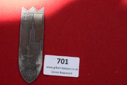 A scarce pressed metal plaque in the form of a shield, depicting the Neptune fountain and city