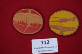 Two scarce lightweight cardboard day badges, each depicting Luftwaffe themes. One shows bombers