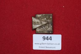 Square bronze badge with superimposed triangular DAF symbol and swastika, commemorating the