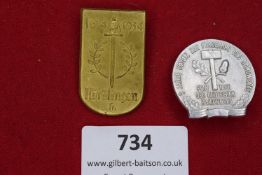 Two German Third Reich Day Badges: one gilt shield-shaped badge for Nördlingen 1634–1934, sword