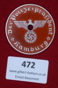 A circular enameled plaque in red and silver, inscribed Der Polizeipräsident Hamburg, with central