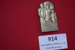 Handwerkertag Stuttgart 1934 Badge – A commemorative badge showing craftsmen figures with an
