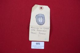 A pressed metal badge commemorating the reunion of the Saar region with Germany in 1935, mounted