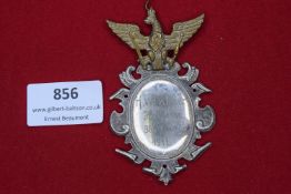 Decorative silvered plaque surmounted by a gilt eagle, engraved “H. Winkler, Helbern, 36 Ring,
