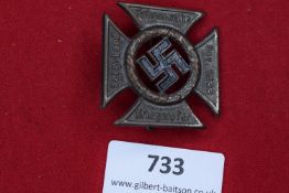 A German Third Reich Day Badge, bronze cross form with central swastika, inscribed Fahnenweihe