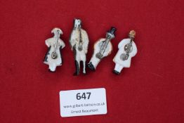 Four German porcelain badges, hand-painted figures depicting a soldier and civilians in