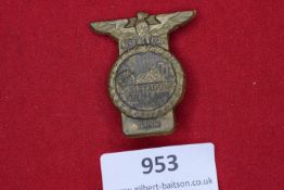 A bronze-coloured pressed metal badge, topped with German eagle and swastika, issued for the NSDAP