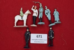 A group of seven painted composition figures, including mounted and foot soldiers, police