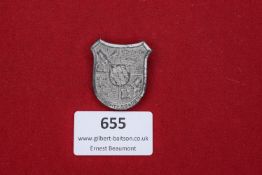A German shield-shaped tinnie badge for Berchtesgaden, 1939/40, marked Deschler & Sohn, München to